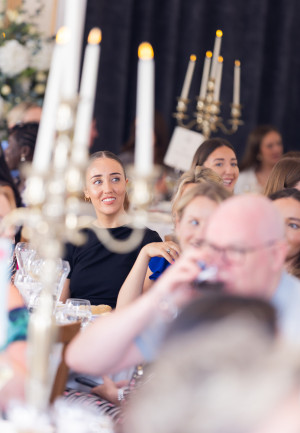 Delegates sitting around tables at an event 